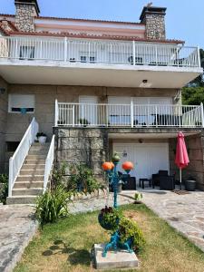a house with a blue statue in front of it at Chalet Lanzada in Sanxenxo