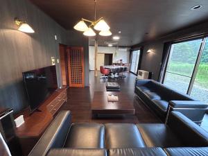 a living room with a couch and a table at Cool-Villa 飛騨リゾート in Hida