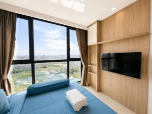 a bedroom with a blue bed and a large window at Sea View Room - Infinity Pool near Terminal 21 in Pattaya