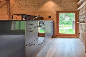 a kitchen in a log cabin with a window at Chalet Nufenen in Ulrichen