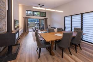 a dining room with a wooden table and chairs at Valley Retreat in Smiths Lake