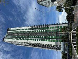 a tall building with green and white windows at Sea View Room - Infinity Pool near Terminal 21 in Pattaya