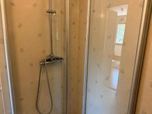 a shower with a hose in a bathroom at Vånga 771 in Örkelsö