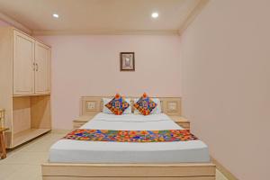 a bedroom with a large bed in a room at FabHotel Vaishanvi Palace in Hyderabad
