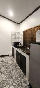 a kitchen with a sink and a counter top at Ladda Garden Home in Klong Muang Beach