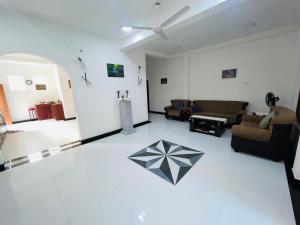 a living room with a couch and a table at Mango Villa Bentota in Bentota
