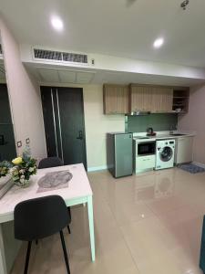 a kitchen with a white table and a stove at Sea View Room - Infinity Pool near Terminal 21 in Pattaya