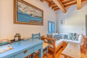 a living room with a blue table and a couch at Villa Antonia in Almyrida