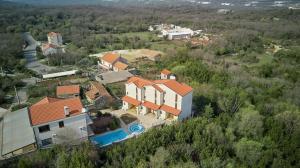 an aerial view of a house with a swimming pool at Villa California in Tivat