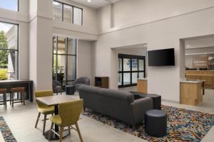 a lobby with a couch and a table and chairs at Hampton Inn & Suites Tilton in Tilton