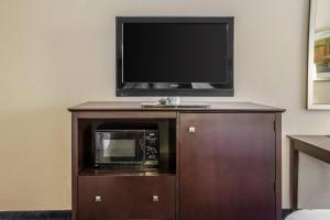 a television on top of a cabinet with a microwave at Econo Lodge Ankeny - Des Moines in Ankeny +15 photos