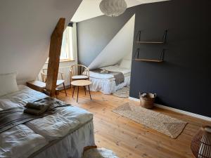 a bedroom with a bed and a chair in a room at Vånga 771 in Örkelsö