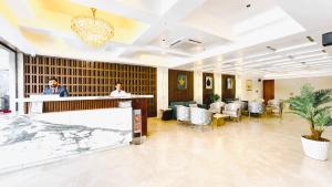 a lobby with a man standing at a counter at Hotel Vintage Zirakpur Chandigarh in Panchkula