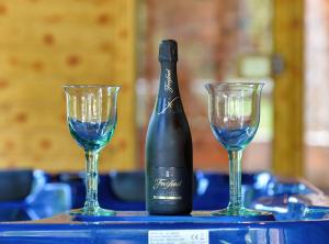 a bottle of wine and two glasses on a table at Requiem Rustical Heaven Villa with Outdoor Pool in Varaždin +21 photos