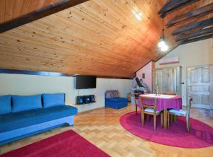 a living room with a blue couch and a table at Requiem Rustical Heaven Villa with Outdoor Pool in Varaždin