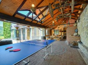 a ping pong table in the middle of a room at Requiem Rustical Heaven Villa with Outdoor Pool in Varaždin