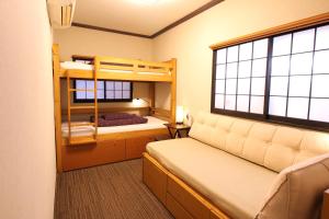 a bedroom with two bunk beds and a window at K's House Tokyo Oasis - Quality Hostel in Asakusa in Tokyo +204 photos