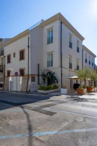 a large white building on the side of a street at Palazzo Partenope in Vasto