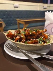 a bowl of food on a plate on a table at Inka Kashi Hostel Varanasi in Varanasi