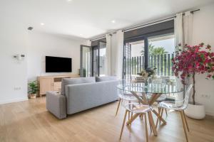 a living room with a couch and a glass table at Adhara lll in Torre del Mar