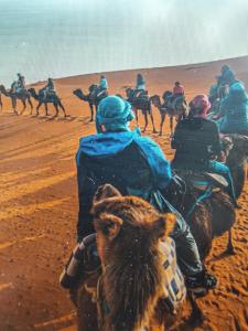 a group of people riding horses in the desert at Bhbs accommodatie Maroc2 in Tazzarine