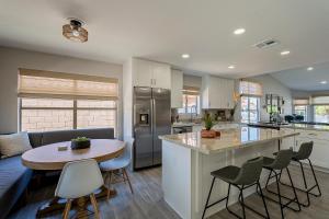 a kitchen and living room with a table and chairs at Dos Palmas - Gilbert Poolside Retreat in Gilbert