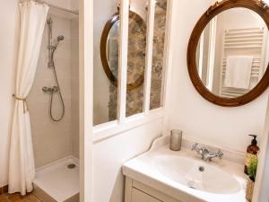 a bathroom with a sink and a mirror at "La Voûte de Pierre" Gîte indépendant in Saint-Cyr +46 photos