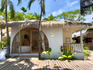 a small house with a thatched roof at Tonsak Resort in Ko Samed