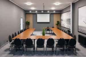 a conference room with a large wooden table and chairs at Hotel ***NAT Sarbinowo in Sarbinowo +53 photos