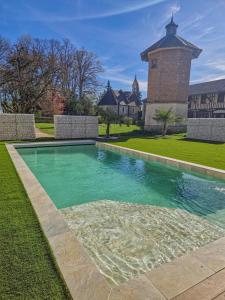 a swimming pool in front of a house at Le château de crespy in Crespy-le-Neuf +22 photos