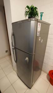 a stainless steel refrigerator with a potted plant on top at Nutria Apt in Cerro Azul with access & ocean view in Cerro Azul
