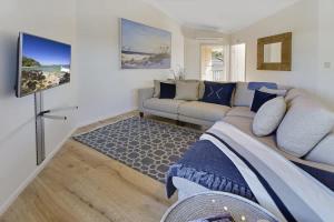 a living room with a bed and a couch at Advance Place in Sunrise Beach