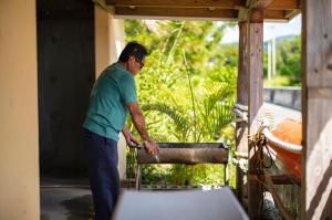 a woman standing in a room with a sink at 海の家 in Kumejima