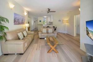 a living room with a couch and a table at Park Cove Apartments in Noosa Heads