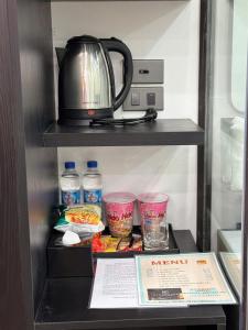 a refrigerator with a tea kettle and some food at Riverside Hotel in Kỳ Vĩ