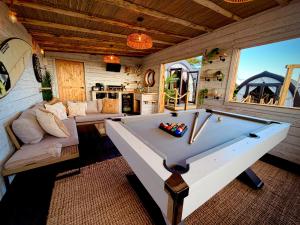 a room with a pool table in a cabin at The Secret Garden Glamping Cornwall in Cury