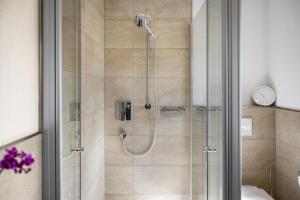 a shower with a glass door in a bathroom at Charmantes Haus mit eigenem Garten in Prien am Chiemsee +24 photos