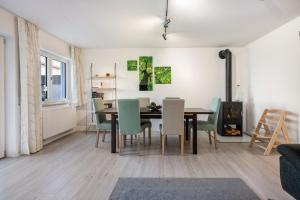 a dining room and living room with a table and chairs at Charmantes Haus mit eigenem Garten in Prien am Chiemsee