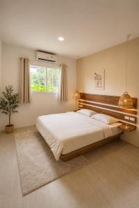 a bedroom with a large bed and a window at Modern Private Pool Villa - 3BR - Koh Phangan in Ko Phangan