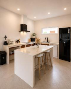 a kitchen with a white island in the middle at Modern Private Pool Villa - 3BR - Koh Phangan in Ko Phangan