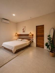 a bedroom with a large bed and a potted plant at Modern Private Pool Villa - 3BR - Koh Phangan in Ko Phangan