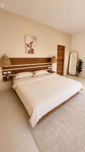 a large bedroom with a large white bed in it at Modern Private Pool Villa - 3BR - Koh Phangan in Ko Phangan +2 photos