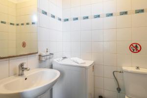 a white bathroom with a sink and a toilet at Halkidiki Sunhouse in Paliouri +25 photos