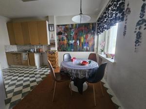 a kitchen with a table and chairs in a room at Rönnypiha 