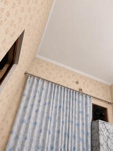a window with a curtain in a room at Theprefabnest in Rishīkesh