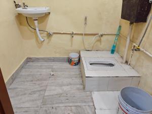 a bathroom with a sink and a toilet at Theprefabnest in Rishīkesh
