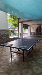 a ping pong table in the middle of a room at Горный уют in Burchmulla