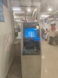 a video game machine in a room with people at Bheemas Grand Ps9 in Srikalahasti
