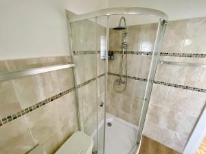 a bathroom with a shower and a toilet at Loewenhoff Seaview Suite 2 in Swakopmund +6 photos
