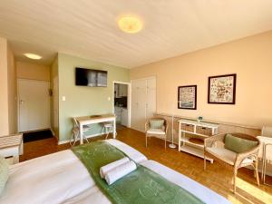 a bedroom with a large bed and a living room at Loewenhoff Seaview Suite 2 in Swakopmund